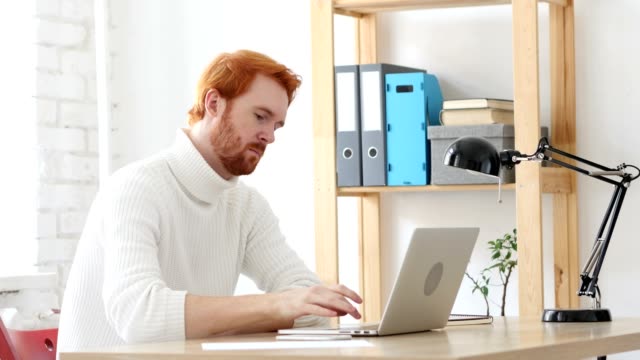 Man-with-Red-Hairs--Thinking-and-working-in-His-Office