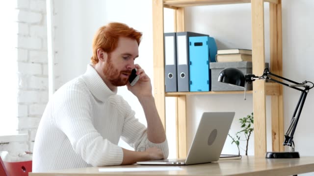 Man-with-Red-Hairs-Talking-on-Phone,-Discussing-on-Smartphone