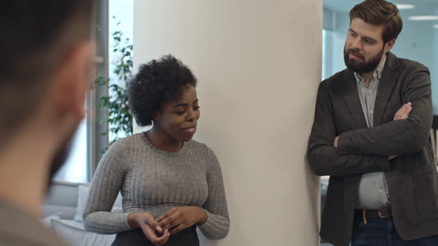 African-Businesswoman-Telling-Funny-Story-to-Coworkers