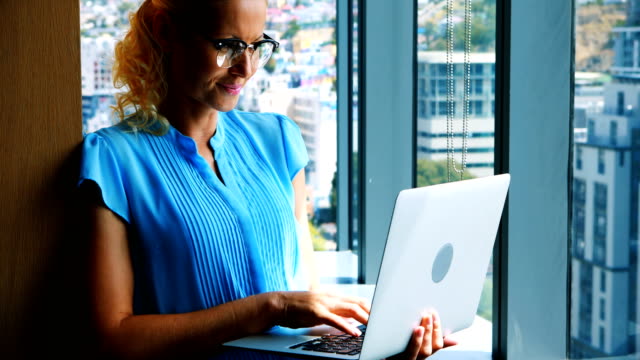 Female-executive-using-laptop
