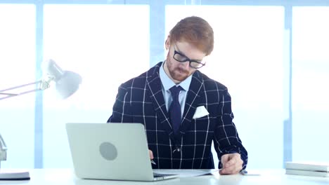 Redhead-Businessman-Writing-in-Office,-Documentation