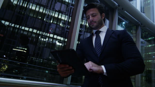 Arabic-businessman-using-wifi-tablet-downtown-office-night