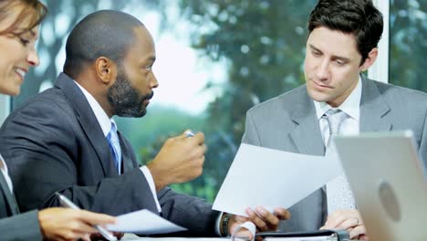 Multi-ethnic-business-managers-discussing-strategy-in-boardroom