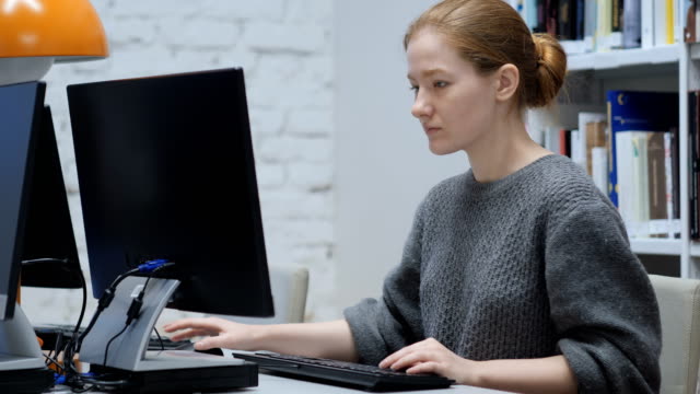 Redhead-Woman-Working-on-Computer-in-Office