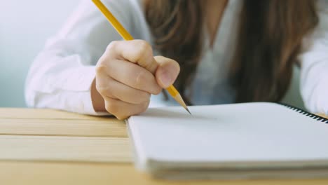 Business-woman-writing-at-desk