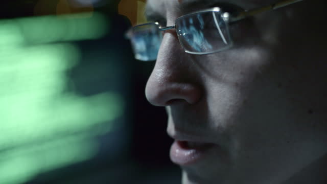 Programmer-in-Eyeglasses-Working-on-Computer-at-Night