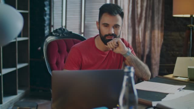 Surprised-man-smiling-while-using-laptop-computer.-Business-man-using-notebook