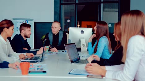 Handsome-young-director-talks-with-colleagues-in-the-conference-room