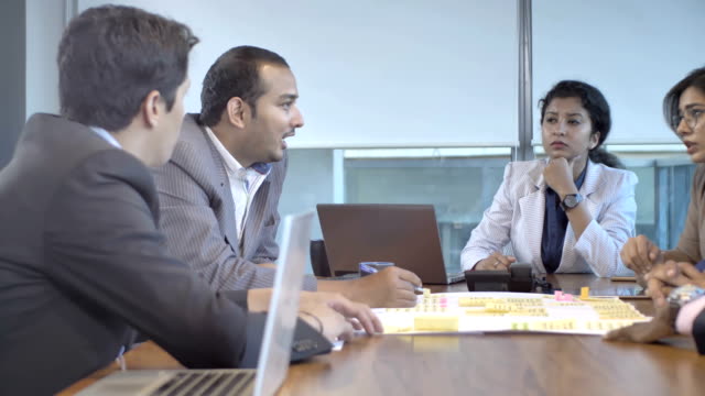 A-motivates-team-of-young-office-coworkers-interacting-in-boardroom