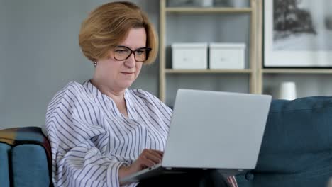 Senior-Woman-Online-Video-Chat-on-Laptop-at-Work
