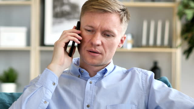 Portrait-of-Businessman-Talking-on-Phone