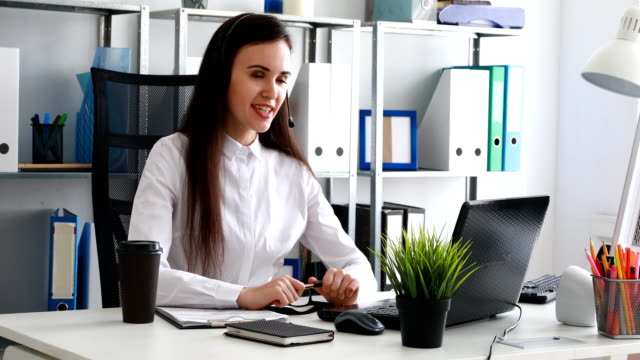 woman-speaking-on-headset-in-modern-office
