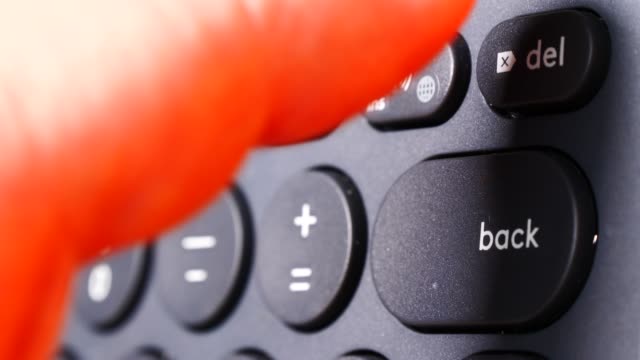 Finger-pressing-backspace-button-on-keyboard