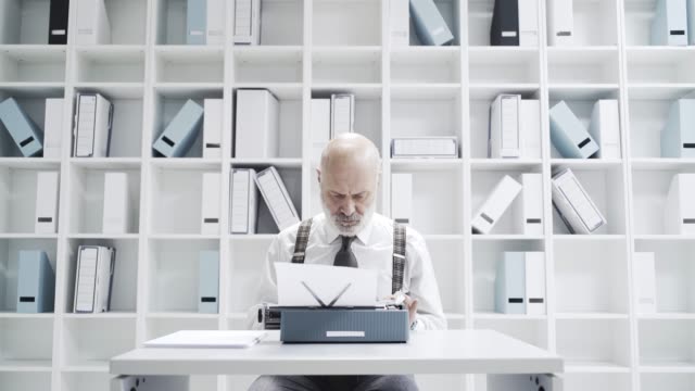 Senior-businessman-typing-on-a-typewriter