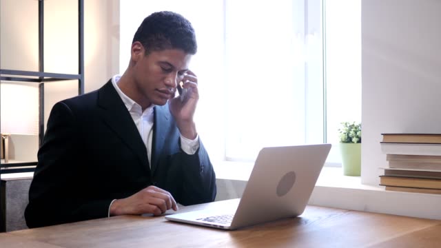 Phone-Talk,-Black-Businessman-Attending-Call-at-Work