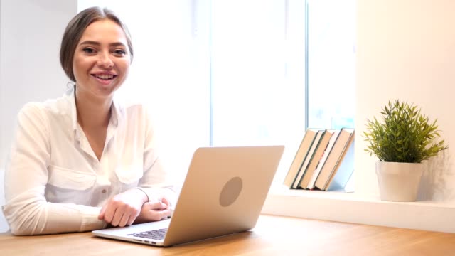 Working-Girl-in-Office-Smiling-Toward-Camera