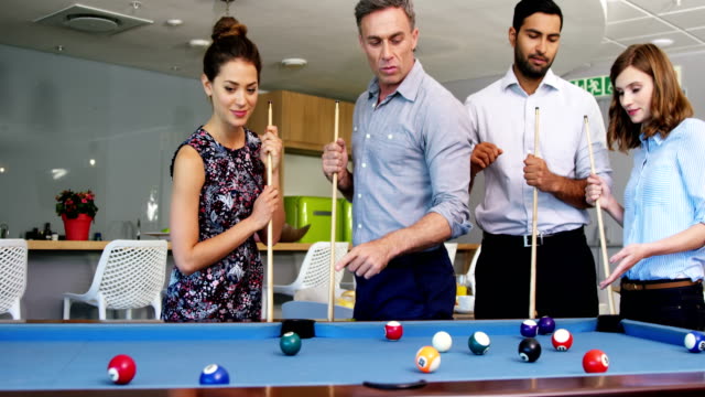 Executives-playing-pool-in-office