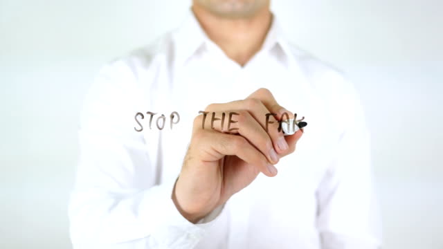 Stop-The-Fake,-Man-Writing-on-Glass