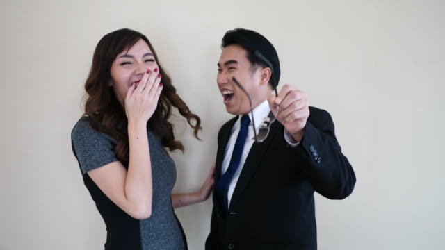 Two-happy-young-business-people-laughing.