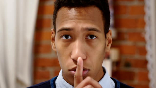Finger-on-Lips,-Young-African-Man-Asking-for-Silence