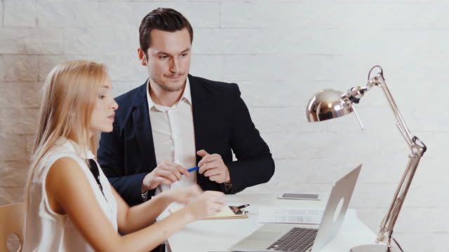 man-and-woman-are-looking-at-the-computer-in-the-office