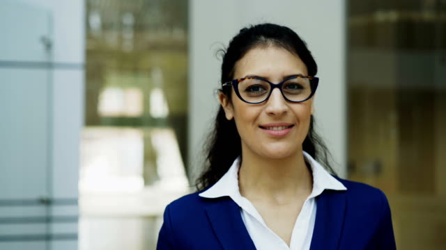 Portrait-of-successful-businesswoman-in-glasses-smiling-in-modern-office