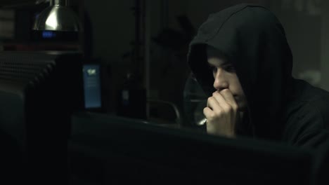 Hacker-connecting-with-his-computers-in-a-dark-basement