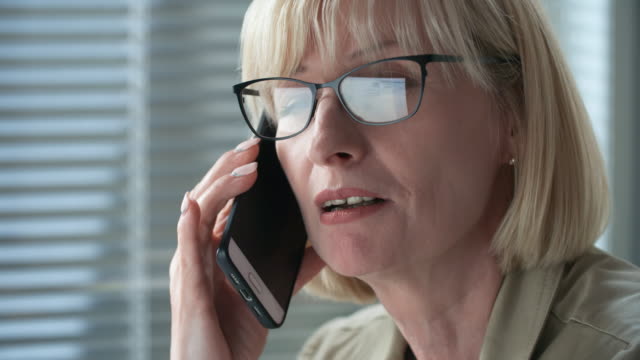 Close-Up-of-Mid-aged-Businesswoman-Talking-on-Phone