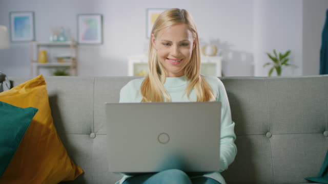 Happy-Pregnant-Woman-Resting-on-a-Sofa-Uses-Laptop-Computer.-Smiling-Beautiful-Future-Mom-Does-Internet-Shopping-on-Computer.