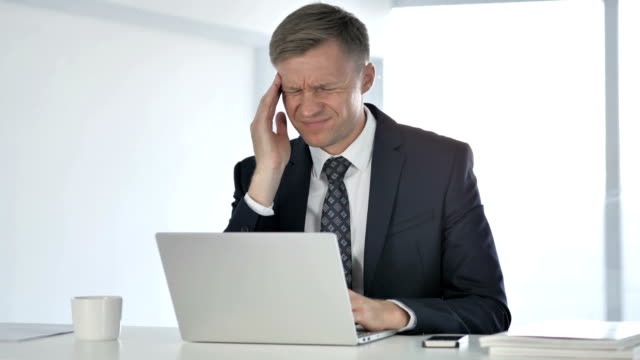 Headache,-Stressed-Businessman-Working-on-Laptop