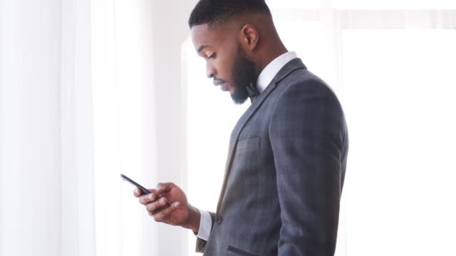 Businessman-text-messaging-on-mobile-phone