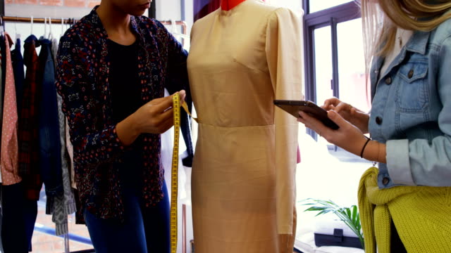 Fashion-designers-measuring-dress-on-dressmakers-model-4k