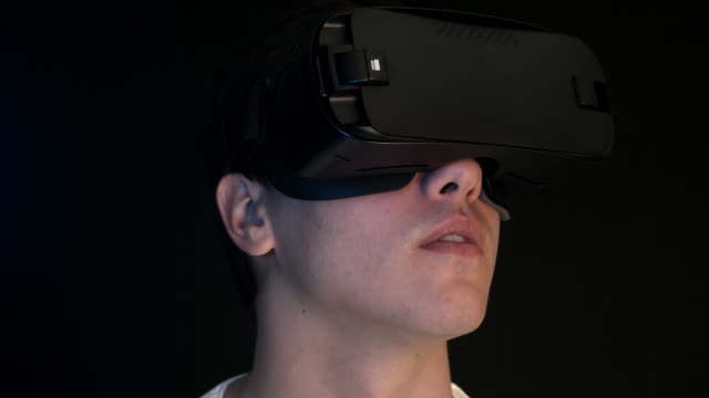 Junger-Mann-tragen-VR-Kopfhörer-und-virtuelle-Realität-erfahren