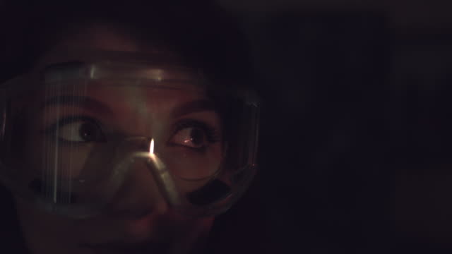 4k-Abstract-Shot-of-a-Woman-Face-and-Glasses-with-Projector-Reflection-of-Fire