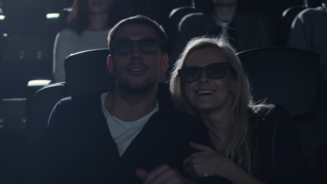 Couple-embrace-each-other-while-having-fun-watching-5d-film-screening-in-cinema.