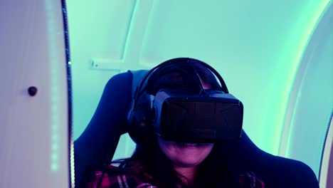 Young-girl-looking-via-virtual-reality-device-and-feeling-scary