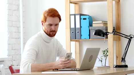 Using-Smartphone,-Browsing-Man-with-Red-Hairs