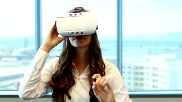 Female-executive-using-virtual-reality-headset