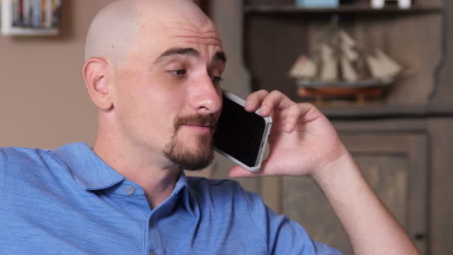 Man-at-home-talking-on-cell-phone