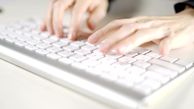 Secretary-woman-working-in-office-with-computer-keyboard-on-white-desk