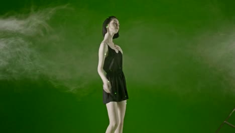 Attractive-girl-,-fashion-model-trendy-and-sensual-dancing-in-a-green-screen