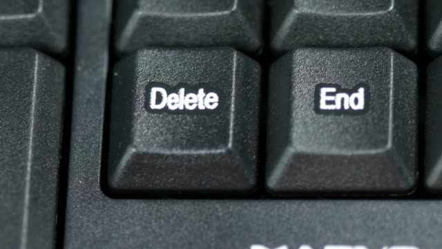 Close-up-of-human-finger-pushing-an-delete-button-on-the-computer-keyboard