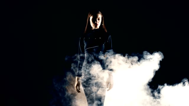 Stylish-fashion-girl-futuristic-technology-black-background-cinematic-lighting-with-smoke-and-backlight-effect.Prores