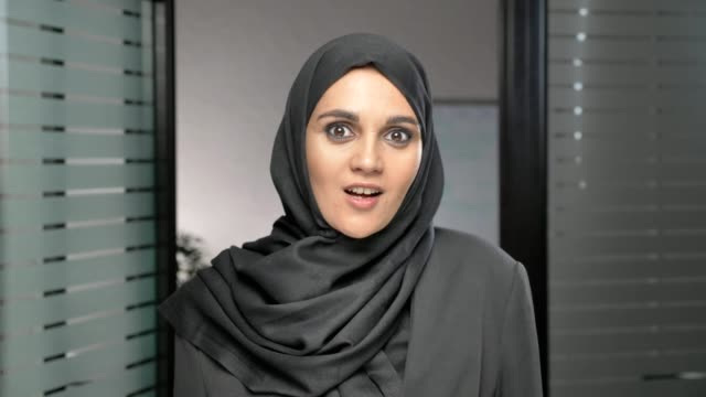 A-young-Arab-girl-in-a-hijab-is-surprised,-indignant-and-looks-at-the-camera.-60-fps
