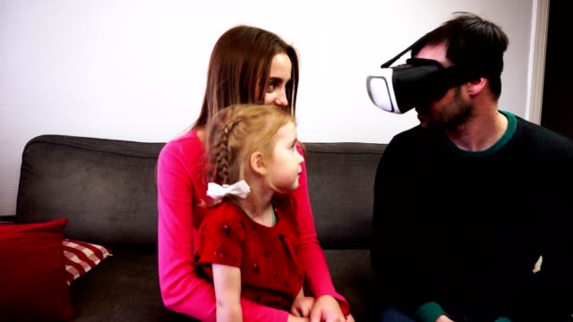 The-father-of-the-family-sits-in-the-virtual-reality-helmet