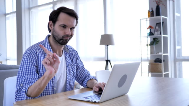 No,-Casual-Beard-Man-Rejecting-by-Waving-Finger,-While-Working-on-Laptop-,4k-,-high-quality