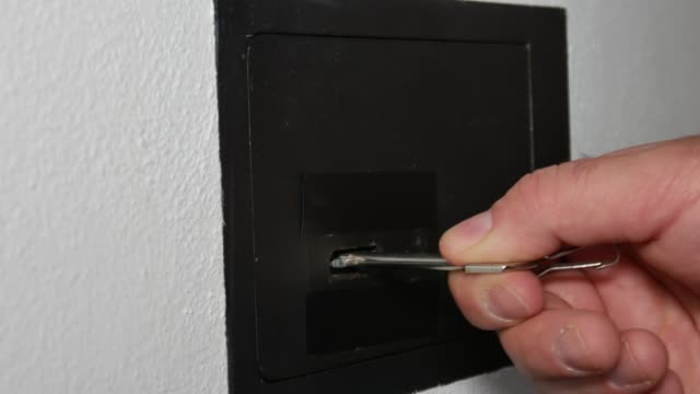 Man-opening-vault-or-safety-deposit-box-in-hotel,-hand-typing-security-code-and-unlocking-the-door-or-the-safe.