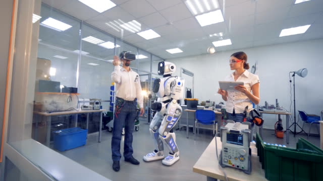 Eine-Person-mit-VR-Brille-testet-einen-Roboter.