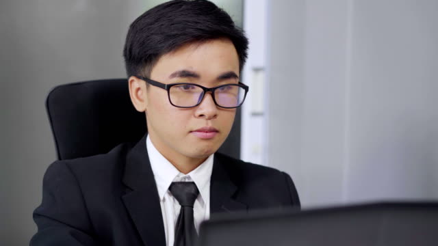 young-business-man-using-laptop-computer