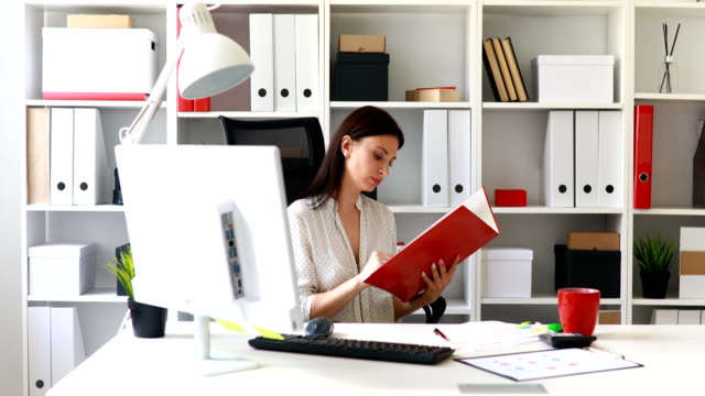 businesswoman-in-white-blouse-examining-documents-in-folder